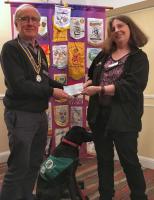 Yasmin Smyth and Suki receiving a cheque from President Geoff